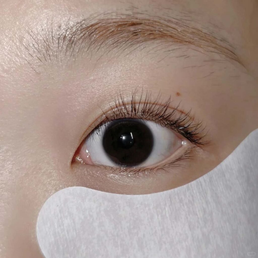 Beautiful young woman demonstrating lash lift results, showcasing naturally curled and volumized lashes without extensions