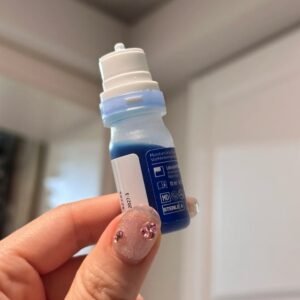 Image Caption Pre-Application Protocol for Eye Drops After Lash Extensions – A Manicured Hand Holding Eye Drop Bottle