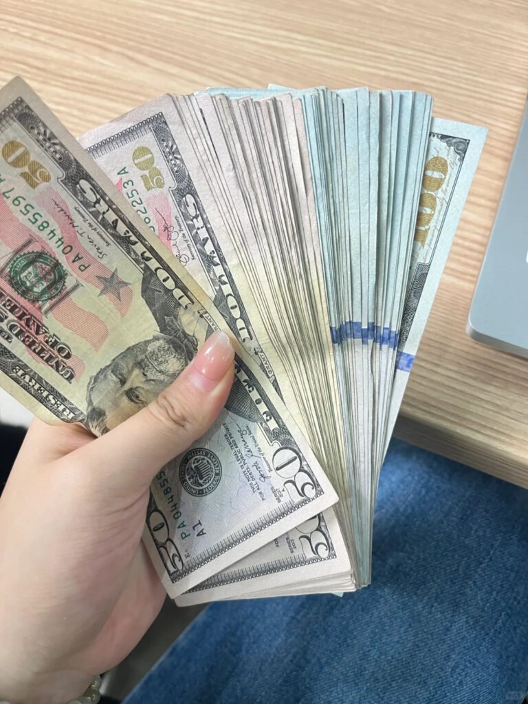 A profitable Shewincosmetic lash client holding a stack of US dollars