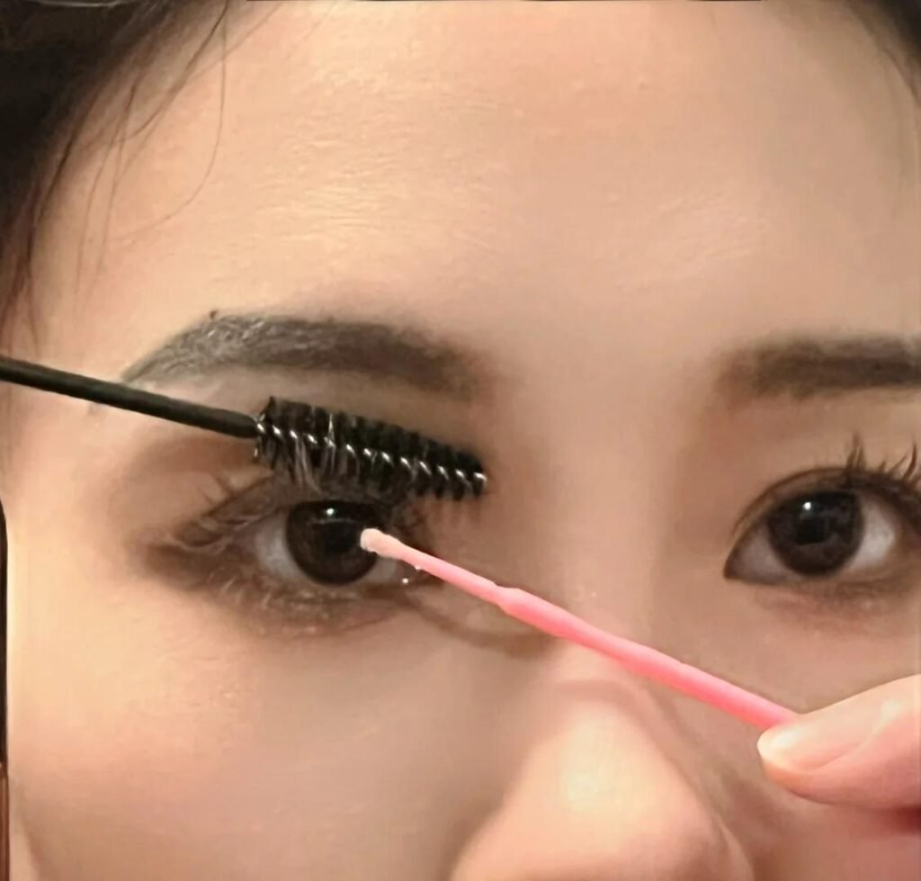 A young woman cleaning her eyelash extensions following Shewincosmetic's guidelines