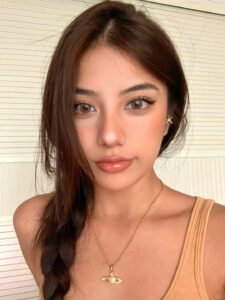 An oval-faced woman showcasing an elegant makeup look with Shewincosmetic eyelash extensions