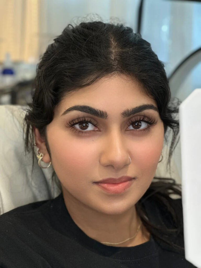 Close-up of a young Arab female model wearing a solid gold nose ring and Shewincosmetic horse hair strip lashes