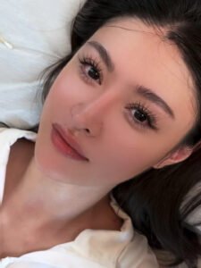 A beautiful young woman confidently wearing Shewincosmetic strip lashes, demonstrating how proper application results in a natural, long-lasting look.