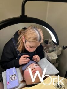 A Shewincosmetic student applying Eyelash Extension Theory during her first live model practice session.