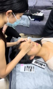 A Shewincosmetic student performing her first ever lash extension mapping on a live model during training