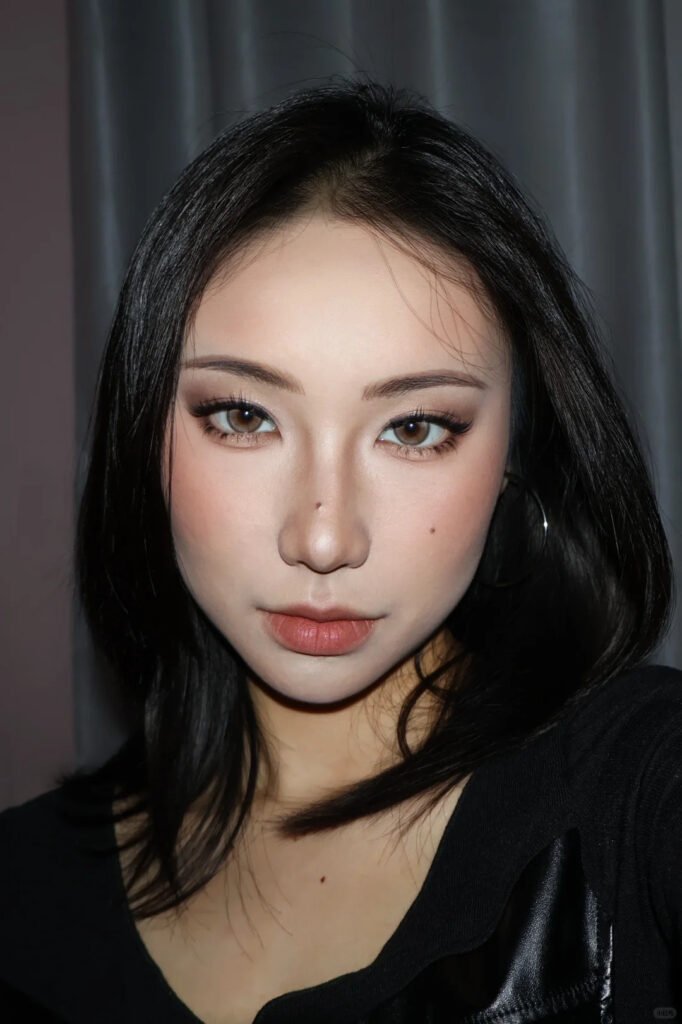 A model showcasing the final result of a beginner lash course, with a full set of volume eyelash extensions