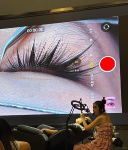 Professional Shewincosmetic instructor teaching students during an Eyelash Extension Training class.