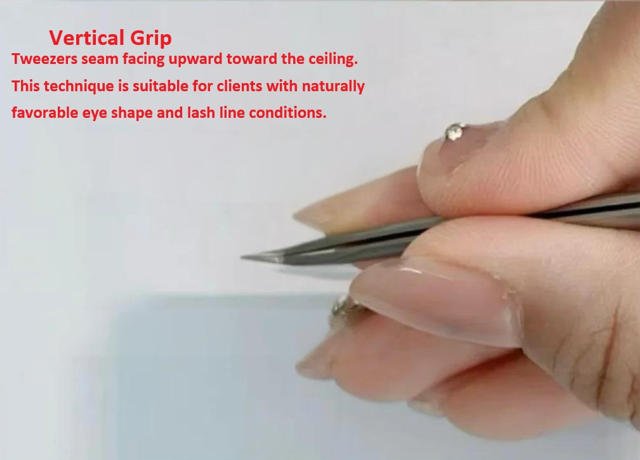 Vertical lash extension grip - tweezers seam facing upward toward ceiling, preserving natural curl memory for wispy styles